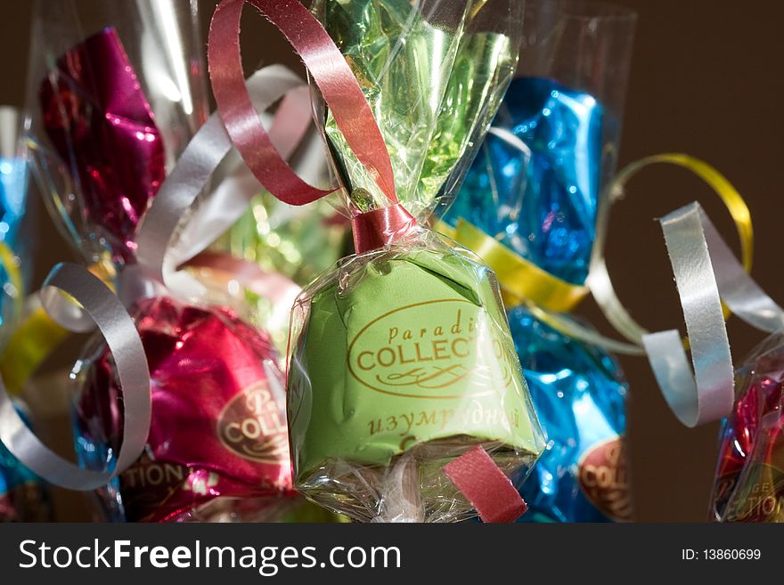 Coloured sweets in gift wrapping with ribbon