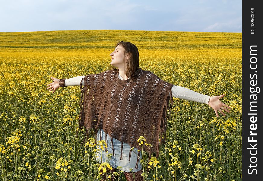 Beautiful woman in field with yellow flowers.