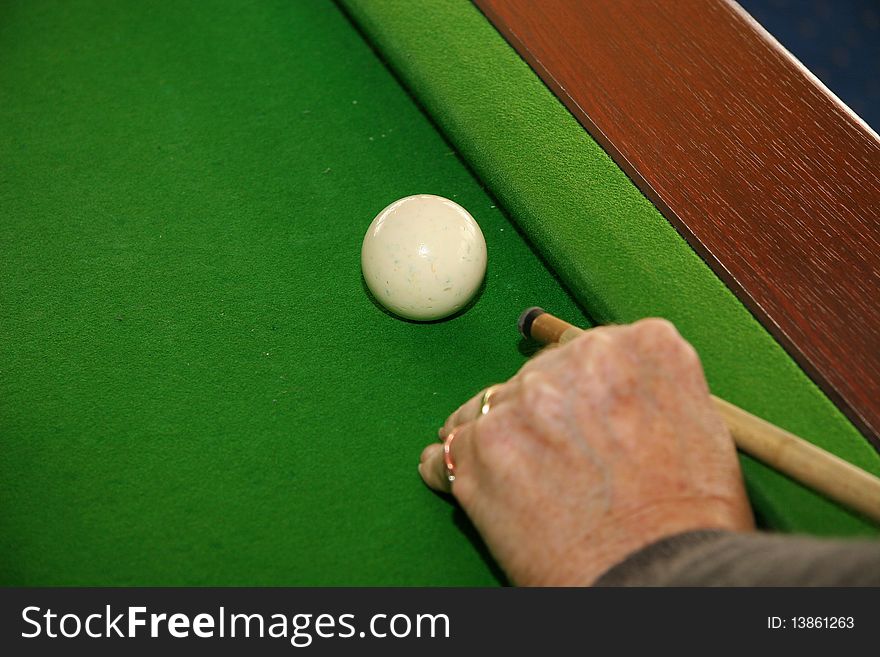 Player cueing the white ball for the next shot