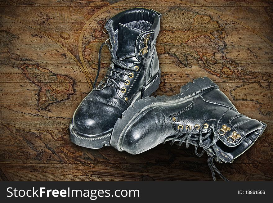 It is an image you want to give the sense of adventure with a map painted on wood and old boots. It is an image you want to give the sense of adventure with a map painted on wood and old boots.