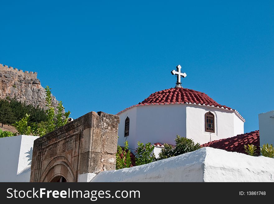 Greek church in santorini greece with a cross