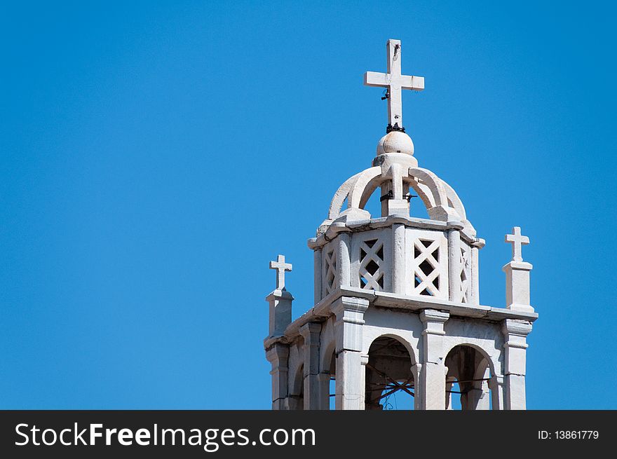 Greek church in santorini greece with a cross