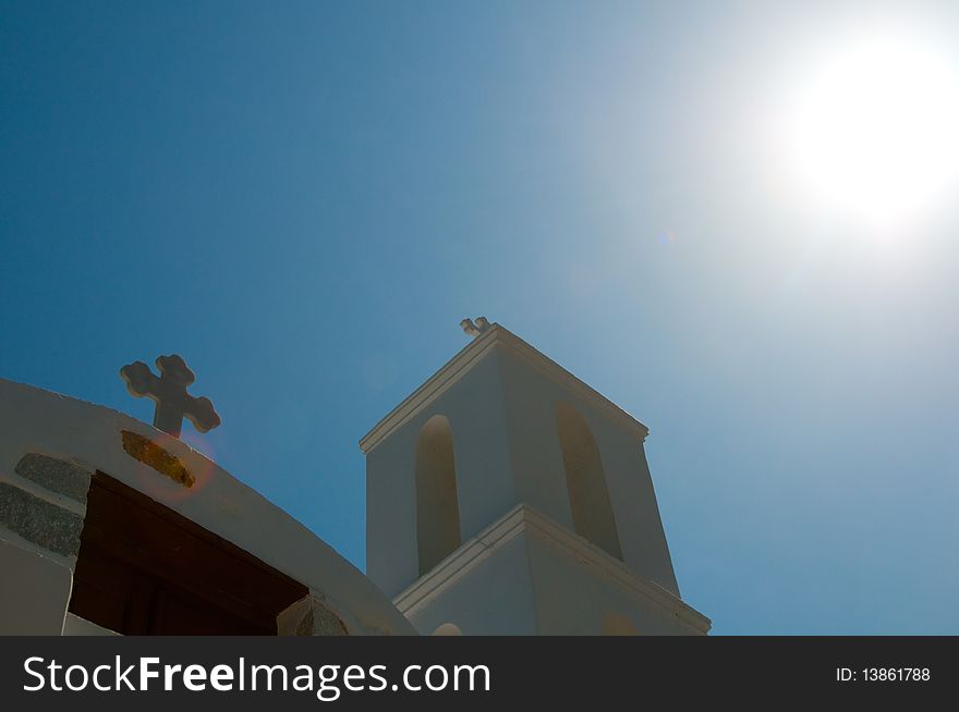 Greek church in santorini greece with a cross