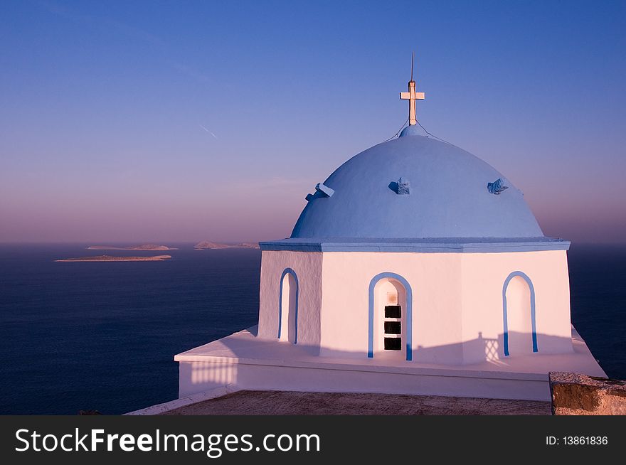 Greek church in santorini greece with a cross