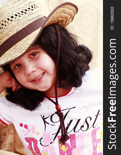 Little girl wearing tan cowboy hat, smiling and happy. Little girl wearing tan cowboy hat, smiling and happy