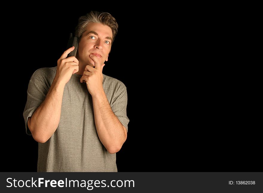 Man using a phone thinking on a black background