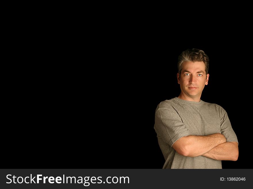 Man standing with confidence on a black background. Man standing with confidence on a black background