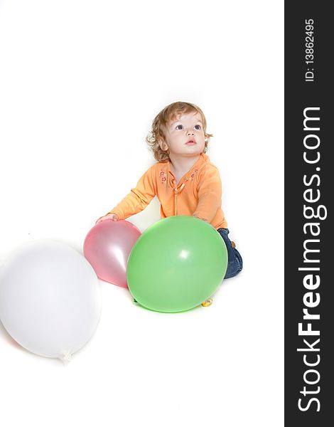 Cute toddler girl with balloons over white