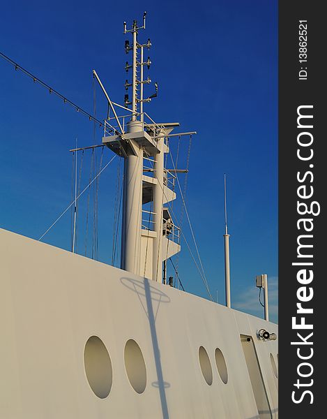 Describes a particular photograph of a cruise ship, in this case of an antenna, there is a background blue sky. Describes a particular photograph of a cruise ship, in this case of an antenna, there is a background blue sky.