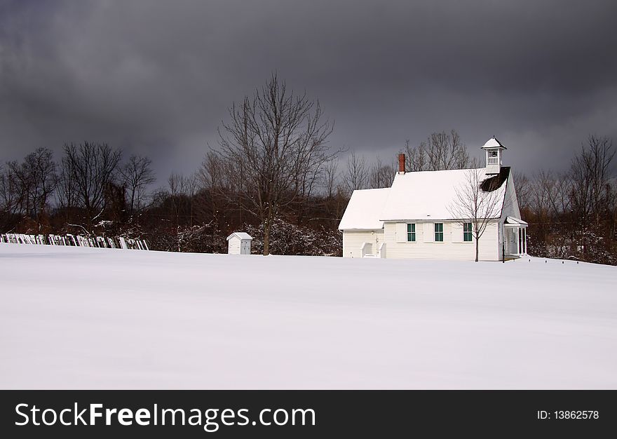 Small historic church on a stormy winter day