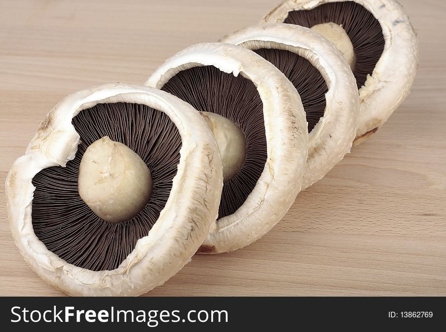 Large mushrooms on on wooden surface. Large mushrooms on on wooden surface