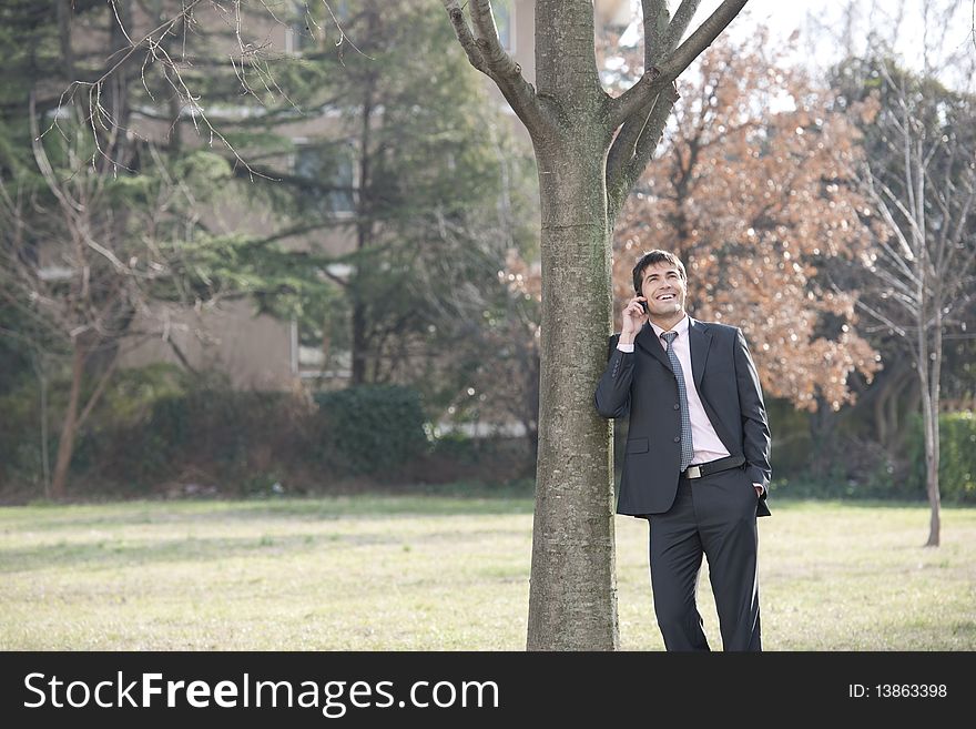 Businessman on the phone outdoors