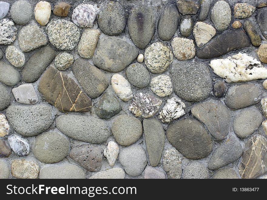 Wall of river stones. Decoration.