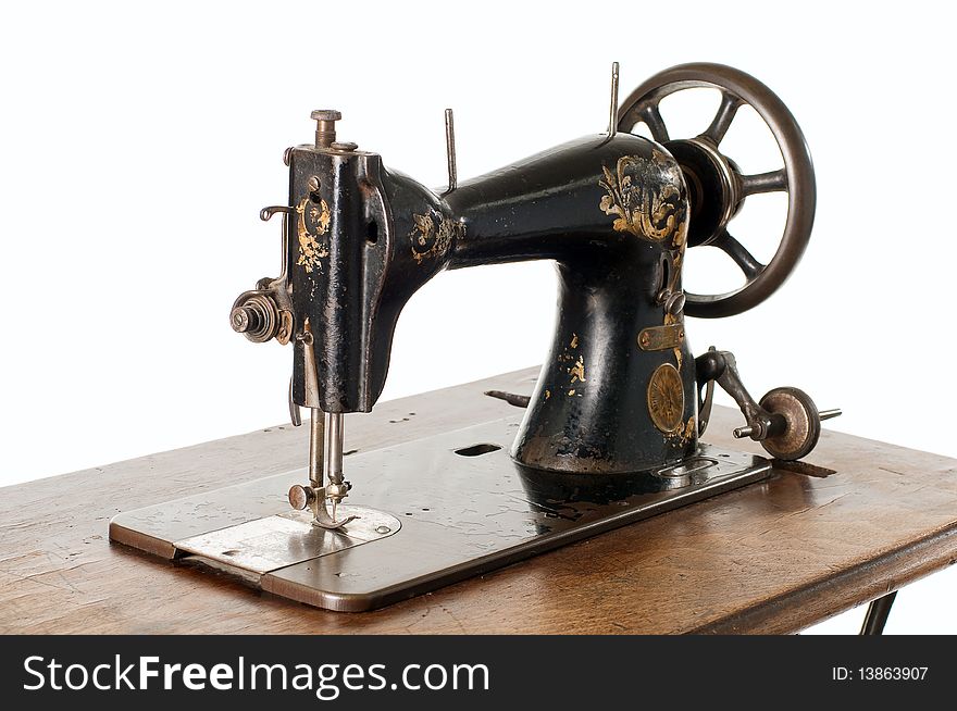 A vintage sewing machine against a white background