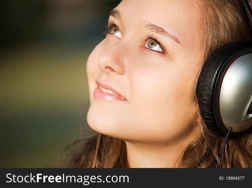 Beautiful happy woman listening to music