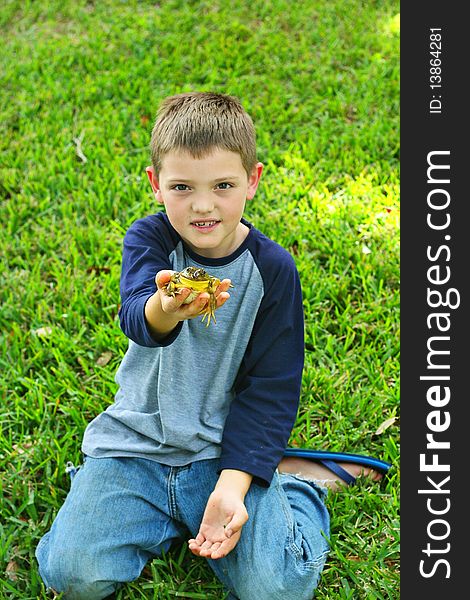 Shot of a handsome little boy showing off his frog