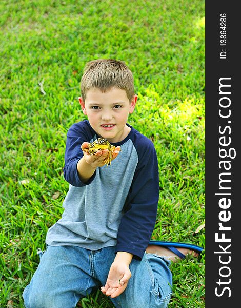 Cute little boy showing off his frog