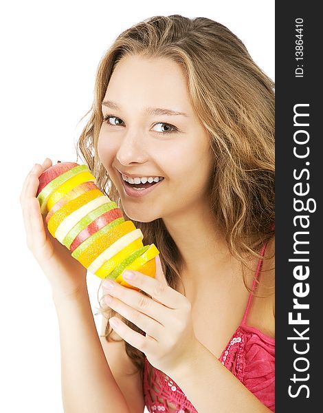 Portrait of happy young woman holding  mixed fruits over white background