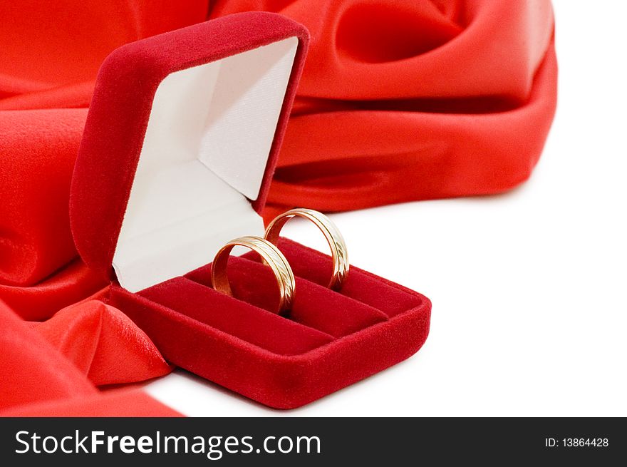 Red box with two gold wedding rings still life
