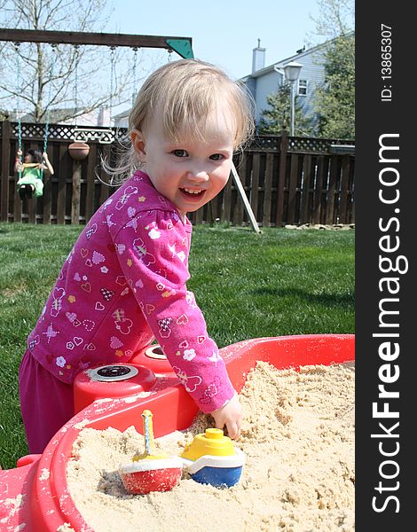 Cute little blonde baby in a sandbox. Cute little blonde baby in a sandbox