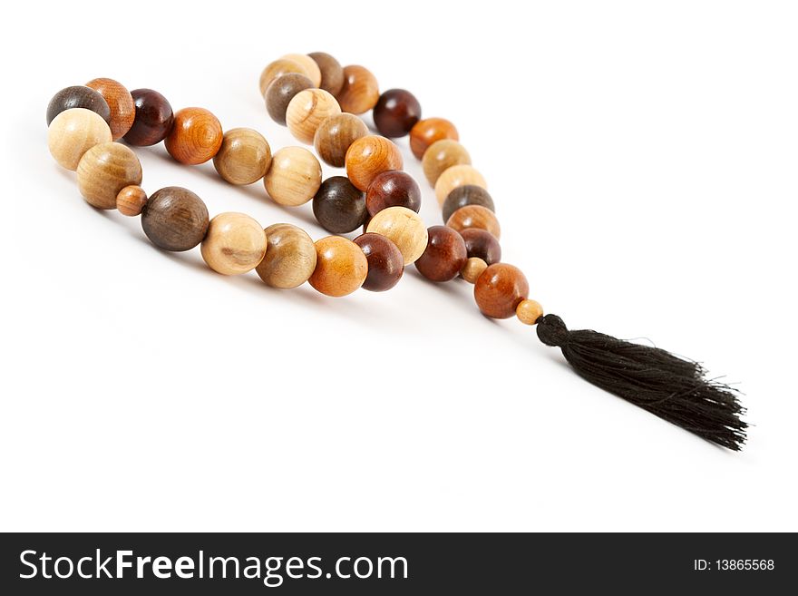 Wooden beads from various breeds of a tree on a white background. Wooden beads from various breeds of a tree on a white background.