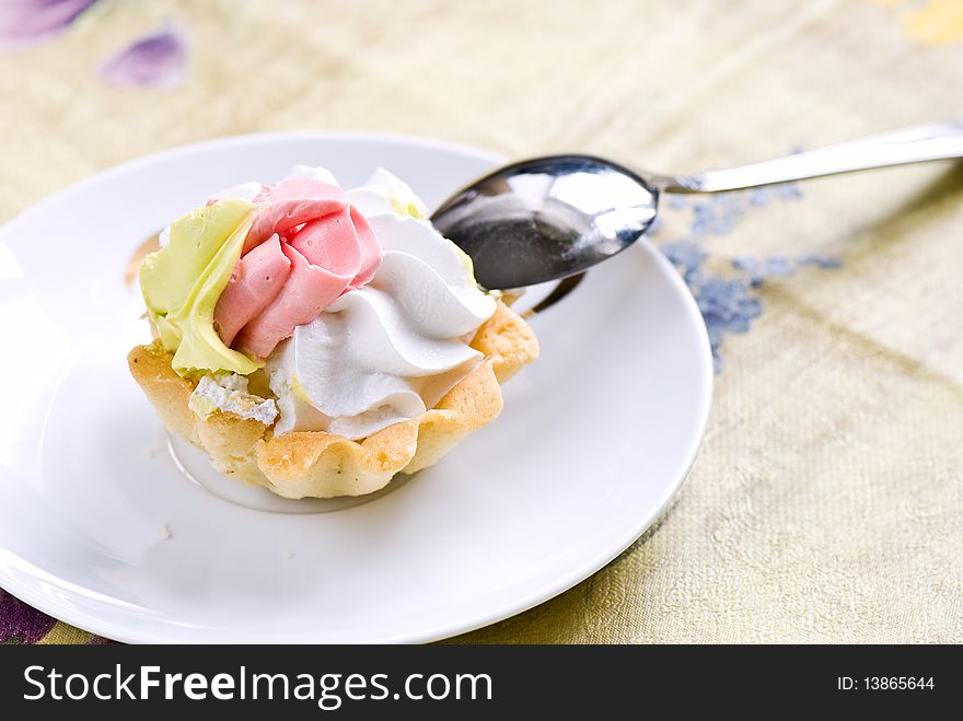 Cake a tartlet with a cream from beaten up whites of eggs on a saucer. Cake a tartlet with a cream from beaten up whites of eggs on a saucer