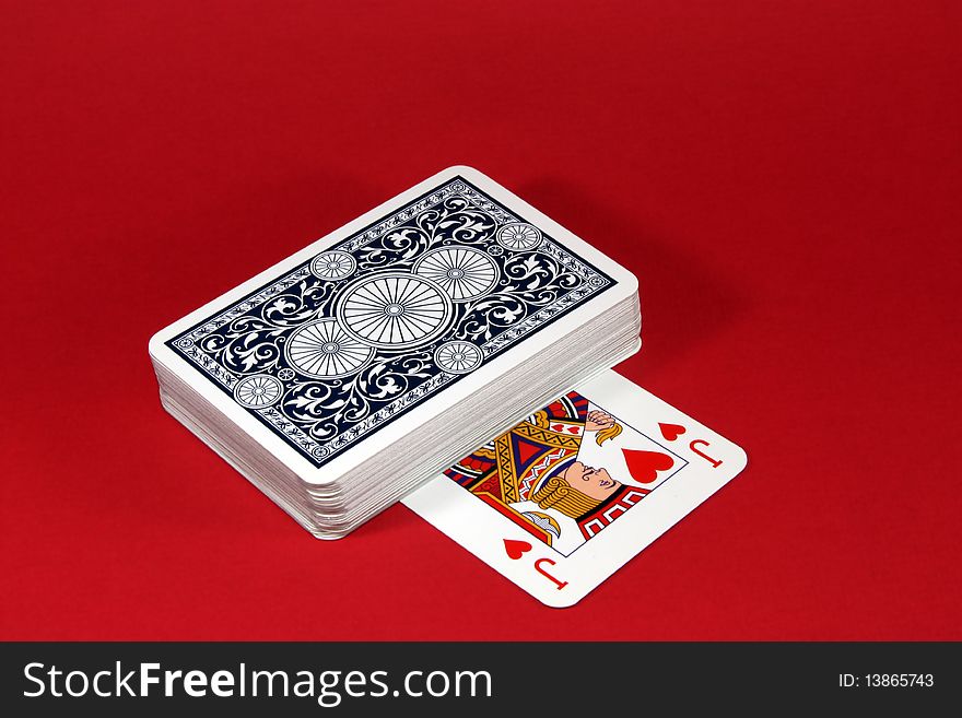 Distribution of playing cards on a red background. Distribution of playing cards on a red background