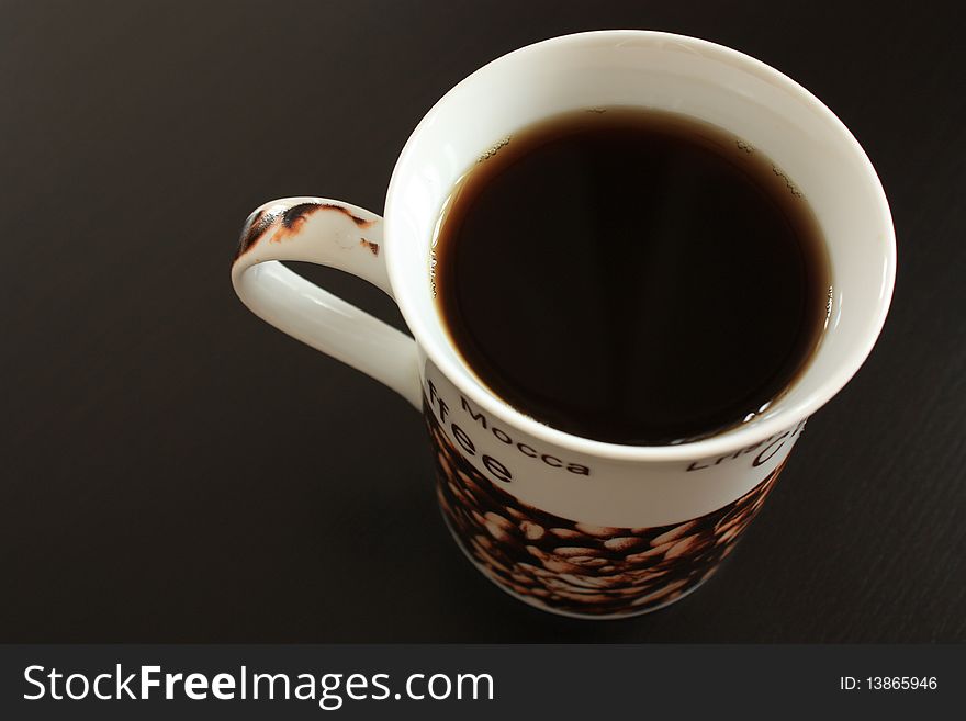 Coffee cup on dark wooden background, selective focus