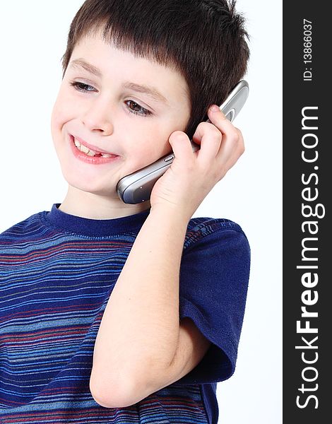 Small boy calling from mobile phone to friend on white background. Small boy calling from mobile phone to friend on white background
