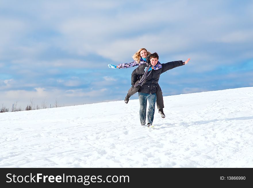 Young guy and the girl walk together in the winter. Young guy and the girl walk together in the winter