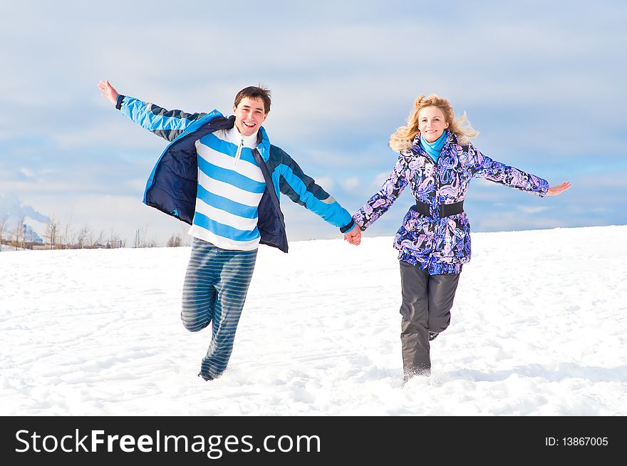 Young guy and the girl walk together in the winter. Young guy and the girl walk together in the winter