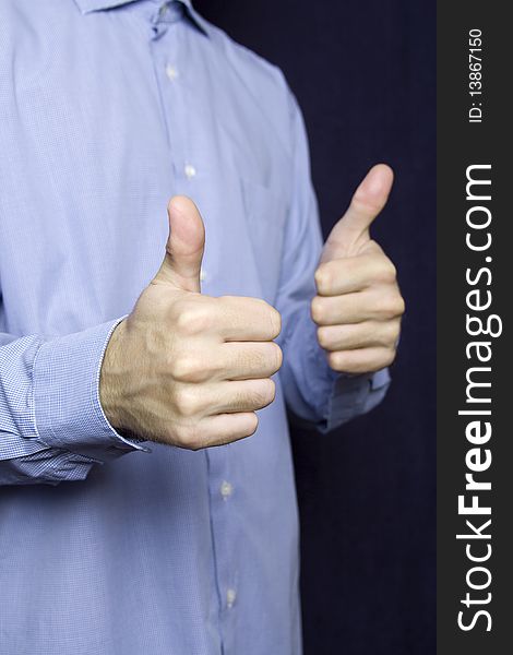 Happy young businessman in a blue shirt with a finger gesture OK. Happy young businessman in a blue shirt with a finger gesture OK