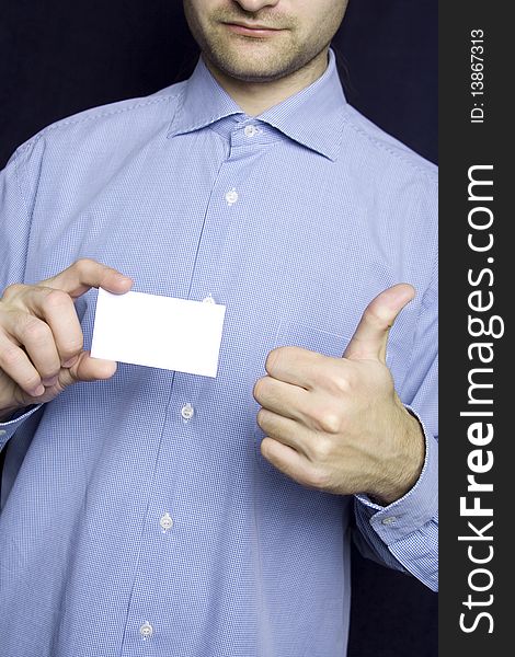 Business young man in a blue shirt holding a blank business card. Another hand the excitement thumb up. Business young man in a blue shirt holding a blank business card. Another hand the excitement thumb up