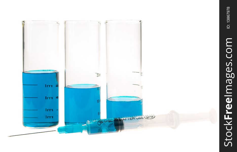 Tubes  and syringe with blue liquid on a white background. Tubes  and syringe with blue liquid on a white background