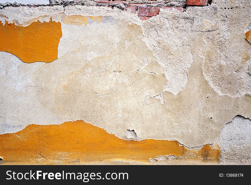 Fragment of tumbledown plastered brick wall. Fragment of tumbledown plastered brick wall
