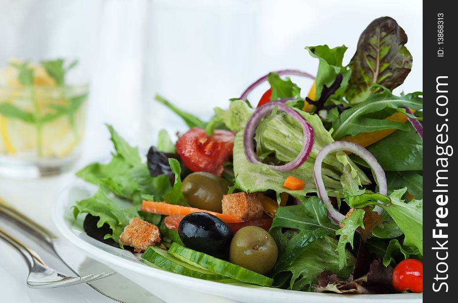 Closeup of mixed lettuce with black and green olive. Closeup of mixed lettuce with black and green olive