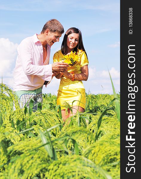 Young lovely couple in a spring field