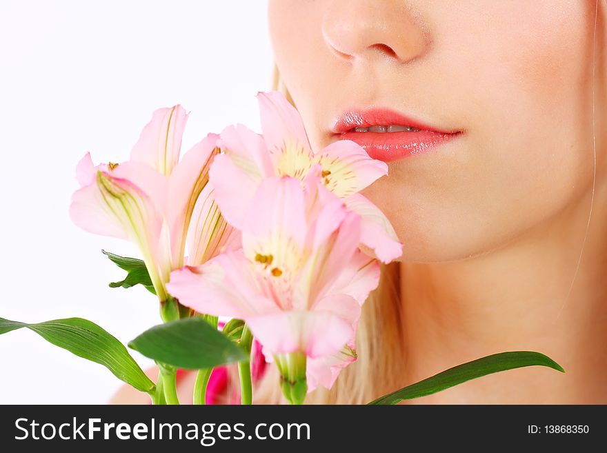 Portrait of a woman holding pink flowers over white background