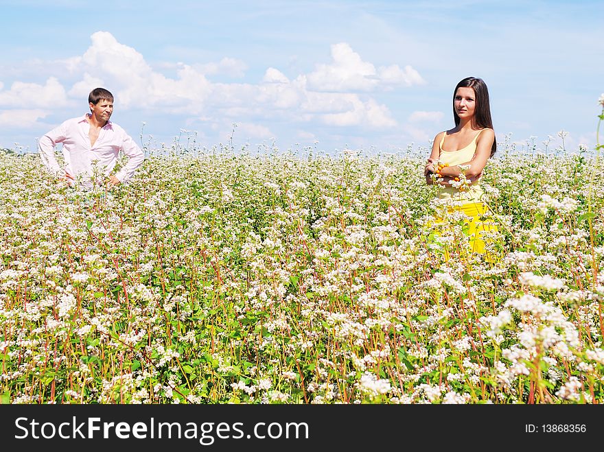 Young lovely couple on a flower field