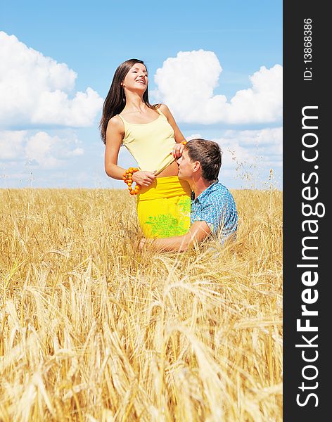 Young lovely couple on a flower field