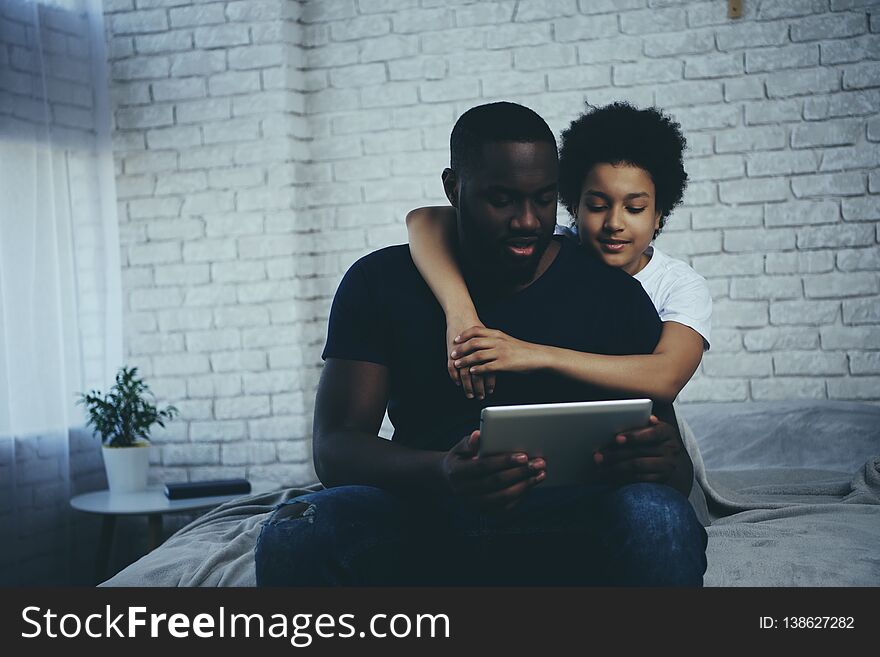 African American boy hugging father who interacts