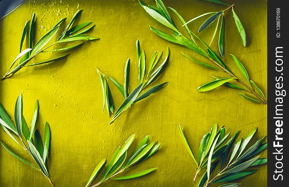 Olive oil puddle with olive branch