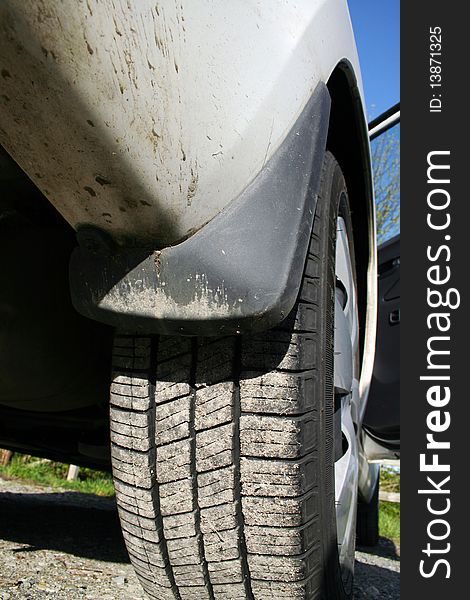 A white car wheel with mud detail. A white car wheel with mud detail.