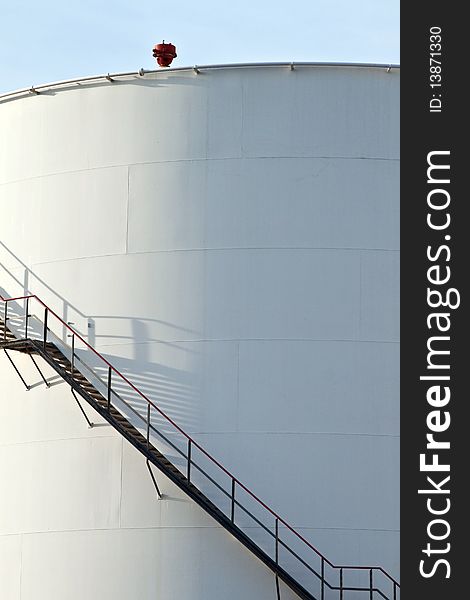 White tanks in tank farm with blue clear sky