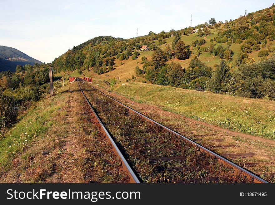The old Ukrainian railway among the mountains, leaving in a distance. The old Ukrainian railway among the mountains, leaving in a distance.