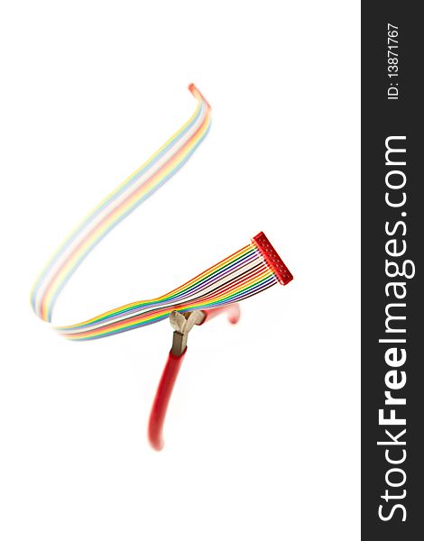 Multi-coloured ribbon cable about to be cut by wire cutters, all floating on a white background. Multi-coloured ribbon cable about to be cut by wire cutters, all floating on a white background.