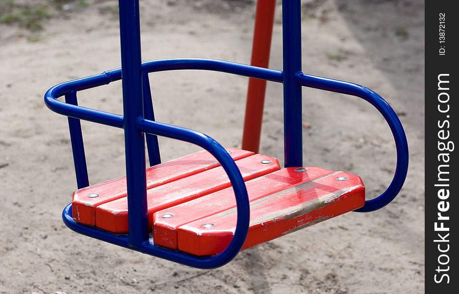 Empty swing of red color