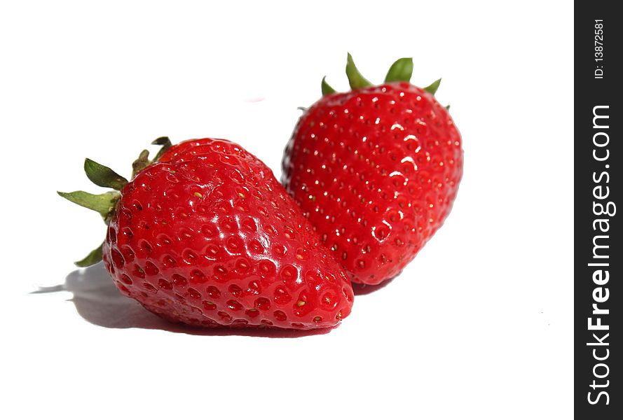 Still life with two strawberries on a white background