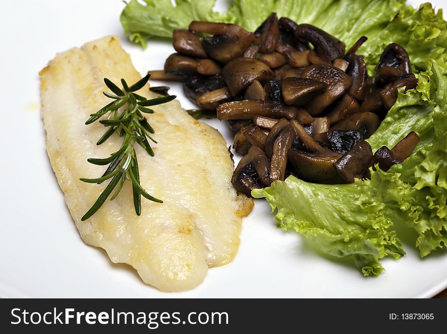 Grilled sole fish with mushrooms and herb