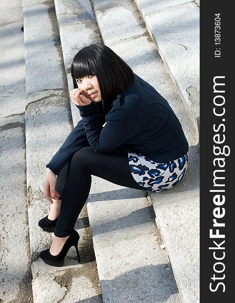 Girl sitting on stairs outdoor